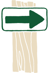 A trail sign with a green arrow pointing to the right