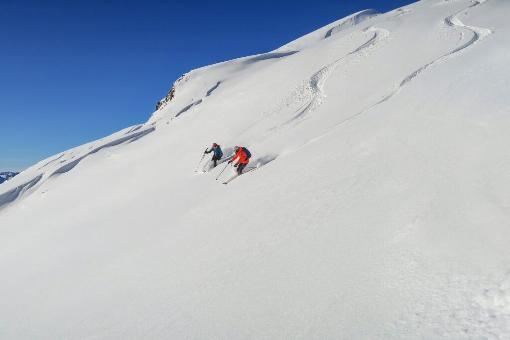 guide and student skiing